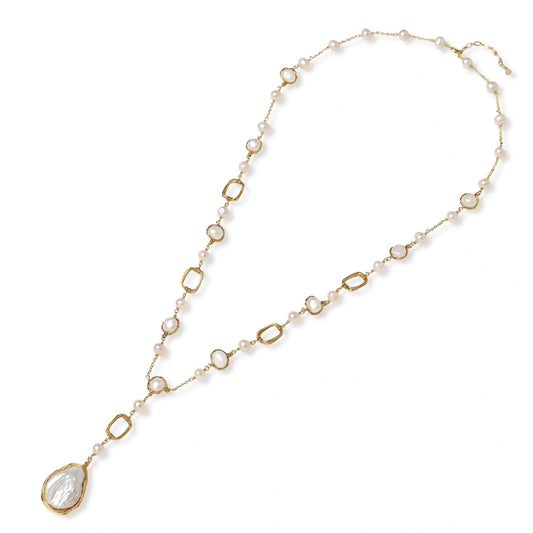 Long gold-plated necklace with alternating freshwater pearls and crystal bezels, featuring a large baroque pearl pendant