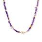Beaded necklace with purple amethyst chips, freshwater pearls, and gold accents on white background.