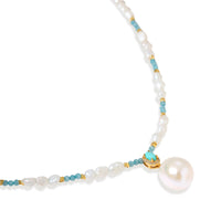 Beaded necklace with baroque pearls, turquoise stones, and gold accents featuring a large pearl pendant on white background.