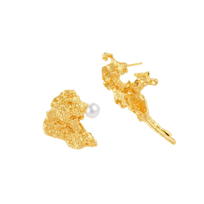 Textured gold stud earrings with coral-like organic surface, one featuring a freshwater pearl, displayed on white background.