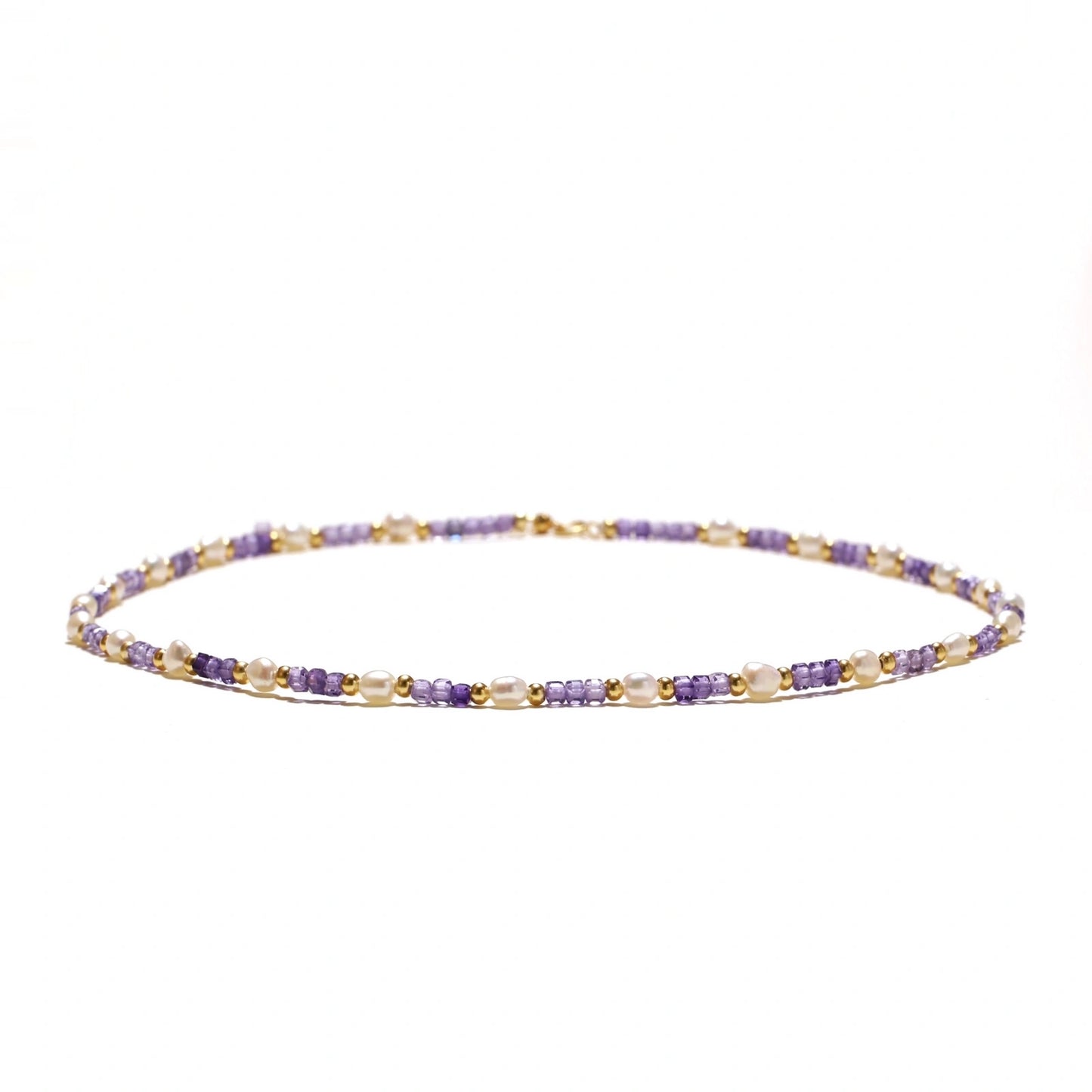 Delicate 18K gold vermeil necklace with alternating lavender zirconia beads and white freshwater pearls on cream background