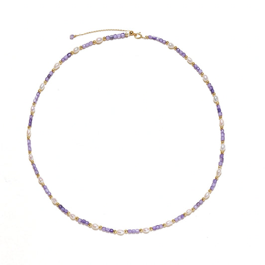 Delicate 18K gold vermeil necklace with alternating lavender zirconia beads and white freshwater pearls on cream background