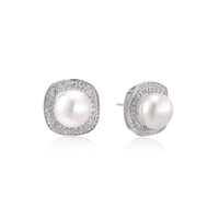 Rhodium-plated sterling silver stud earrings with round freshwater pearls surrounded by geometric crystal halos on cream background.