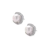 Rhodium-plated sterling silver stud earrings with round freshwater pearls surrounded by geometric crystal halos on cream background.