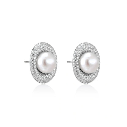 Elegant stud earrings with cream freshwater pearls surrounded by sparkly pavé crystals on rhodium-plated silver setting