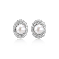 Elegant stud earrings with cream freshwater pearls surrounded by sparkly pavé crystals on rhodium-plated silver setting