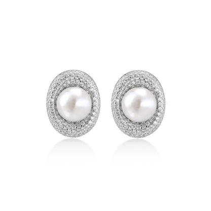 Elegant stud earrings with cream freshwater pearls surrounded by sparkly pavé crystals on rhodium-plated silver setting