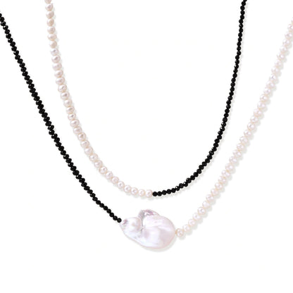 Double-strand necklace with black faceted quartz and white pearls featuring an oversized baroque pearl centerpiece