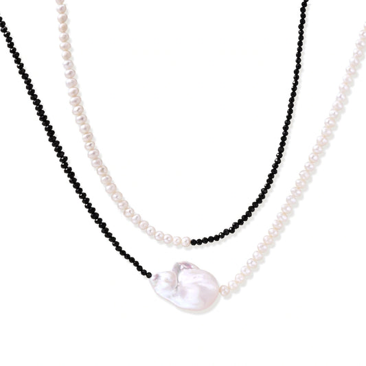 Double-strand necklace with black faceted quartz and white pearls featuring an oversized baroque pearl centerpiece