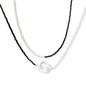 Double-strand necklace with black faceted quartz and white pearls featuring an oversized baroque pearl centerpiece