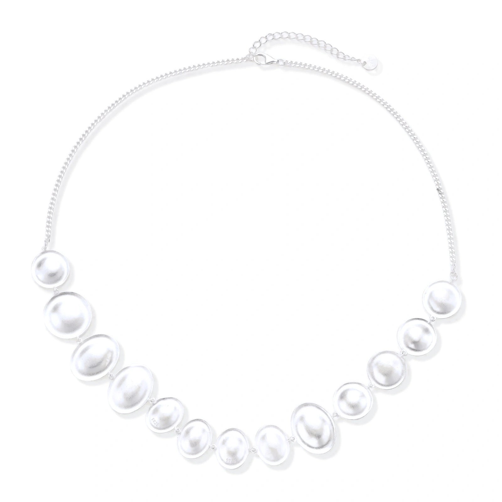 Graduated pearl-finish silver discs forming an organic bubble bib necklace on delicate chain against cream background.