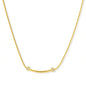 Delicate gold-plated necklace with curved bar pendant and crystal accents on snake chain against cream background.
