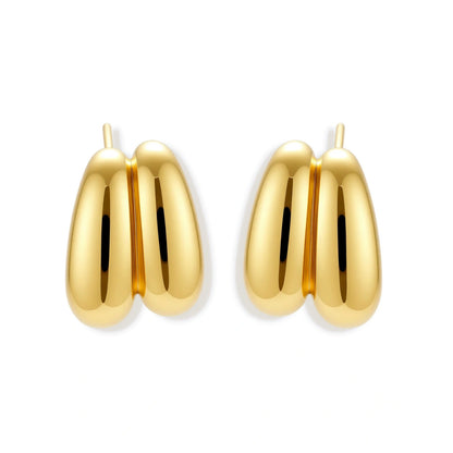 Chunky 18K gold-plated sterling silver hoop earrings with flowing sculptural curves on white background.