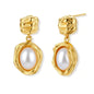 Gold-plated textured stud earrings with white freshwater pearl drops against cream background, showing organic rippled design