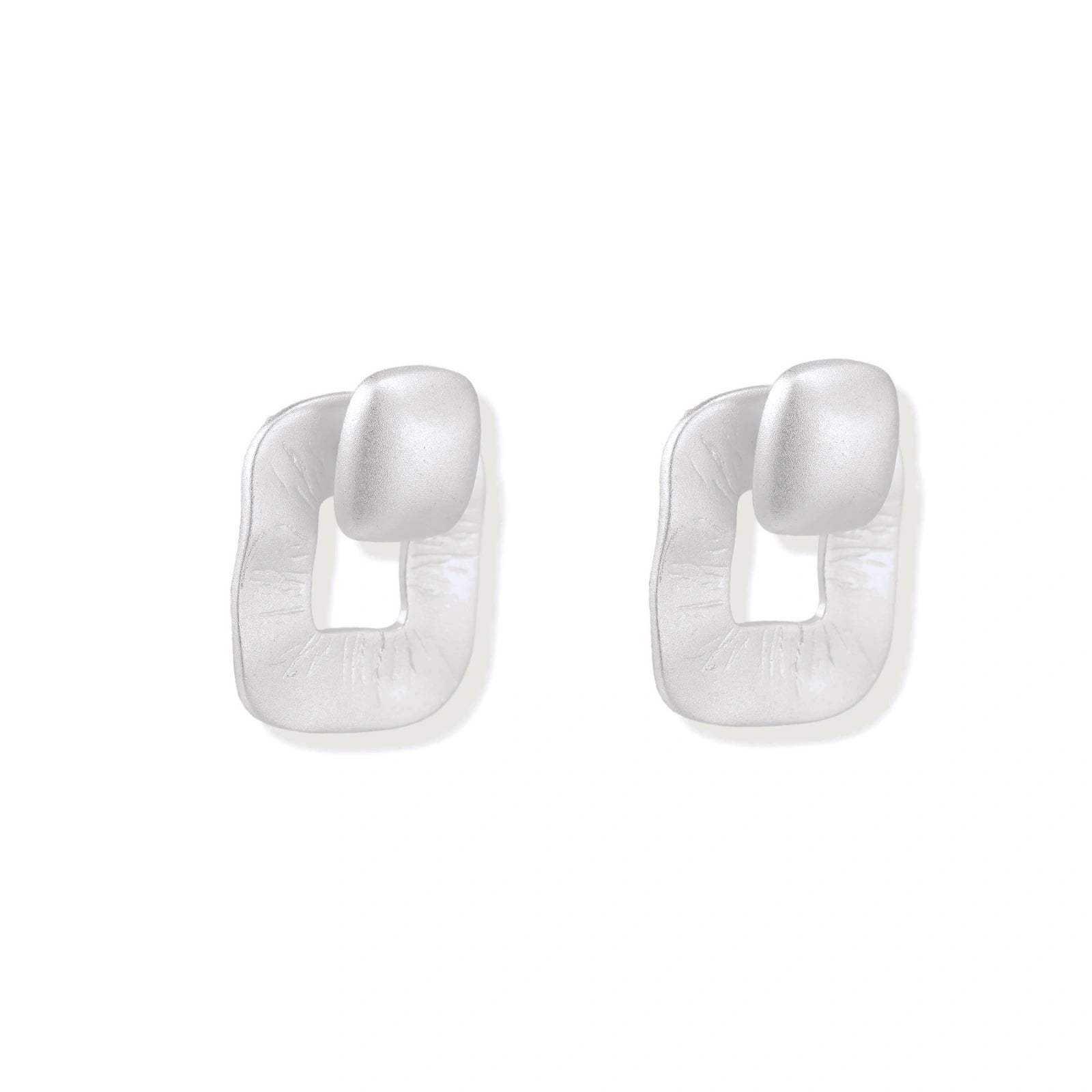 Pair of geometric sterling silver earrings with frosted square frames and glossy rounded studs on white background
