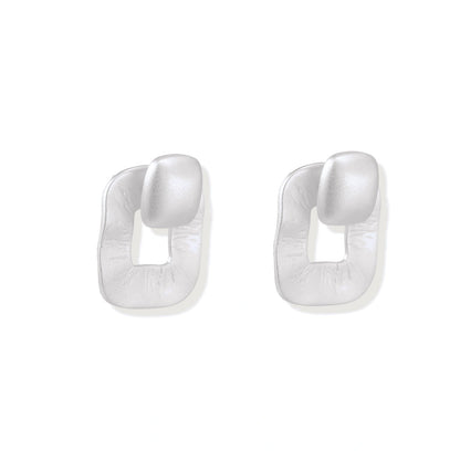Pair of geometric sterling silver earrings with frosted square frames and glossy rounded studs on white background
