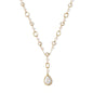 Long gold-plated necklace with alternating freshwater pearls and crystal bezels, featuring a large baroque pearl pendant
